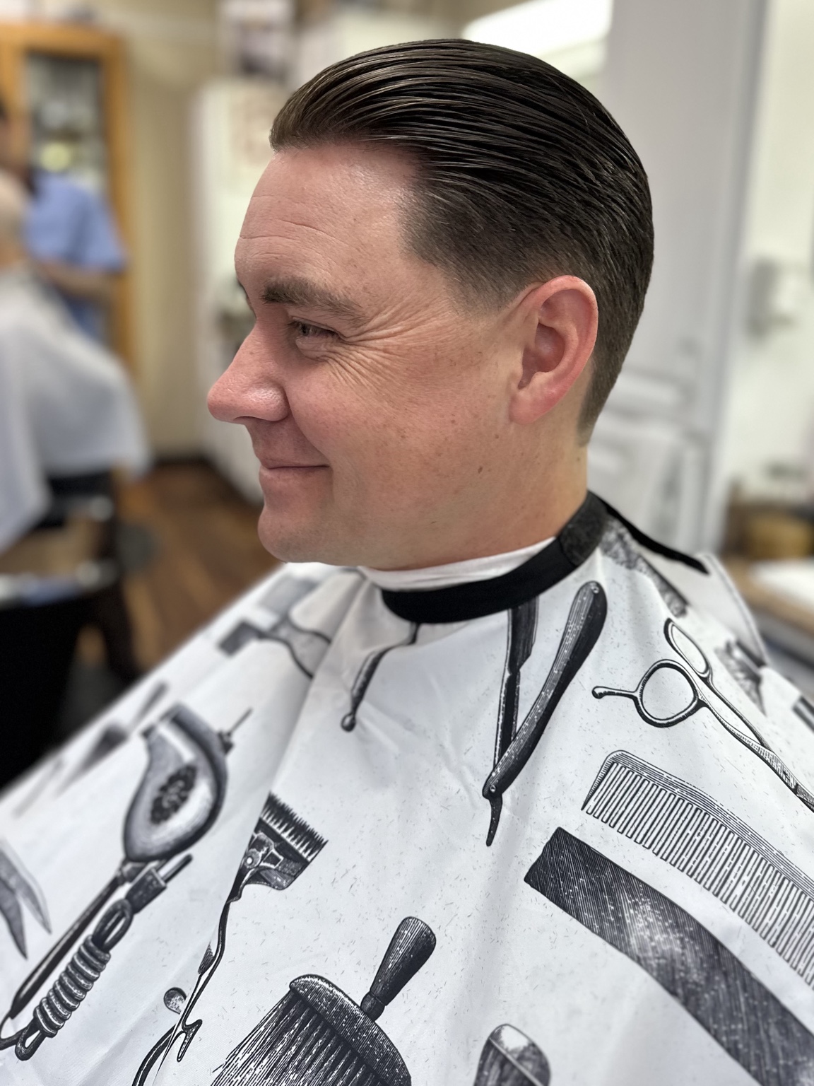 Classic slick back haircut by Kandice Maxine